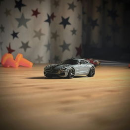 a toy car sitting on top of a wooden floor